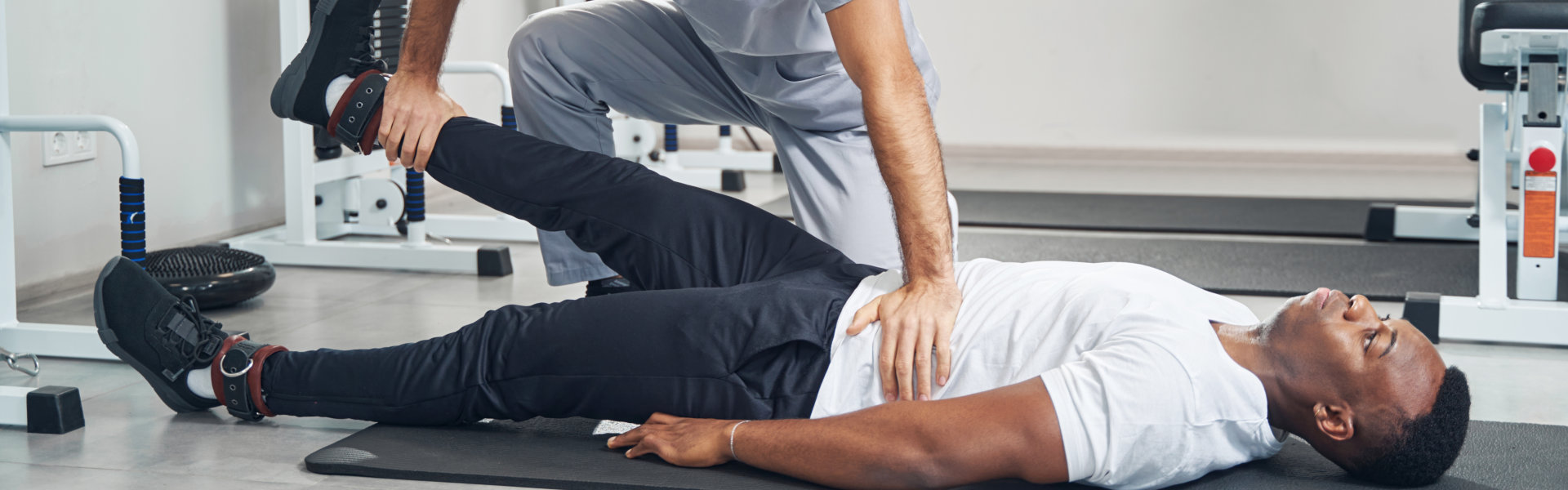 Physiotherapist performing straight leg raise test on patient