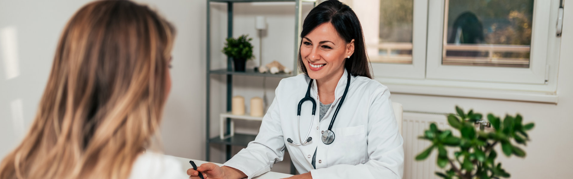 Friendly female doctor in conversation with female patient